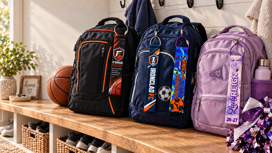Lifestyle concept: Forge Basketball, Ironclad FC, Halloween Havoc, and Lady Reign BagTagz on three sports backpacks in a family mudroom